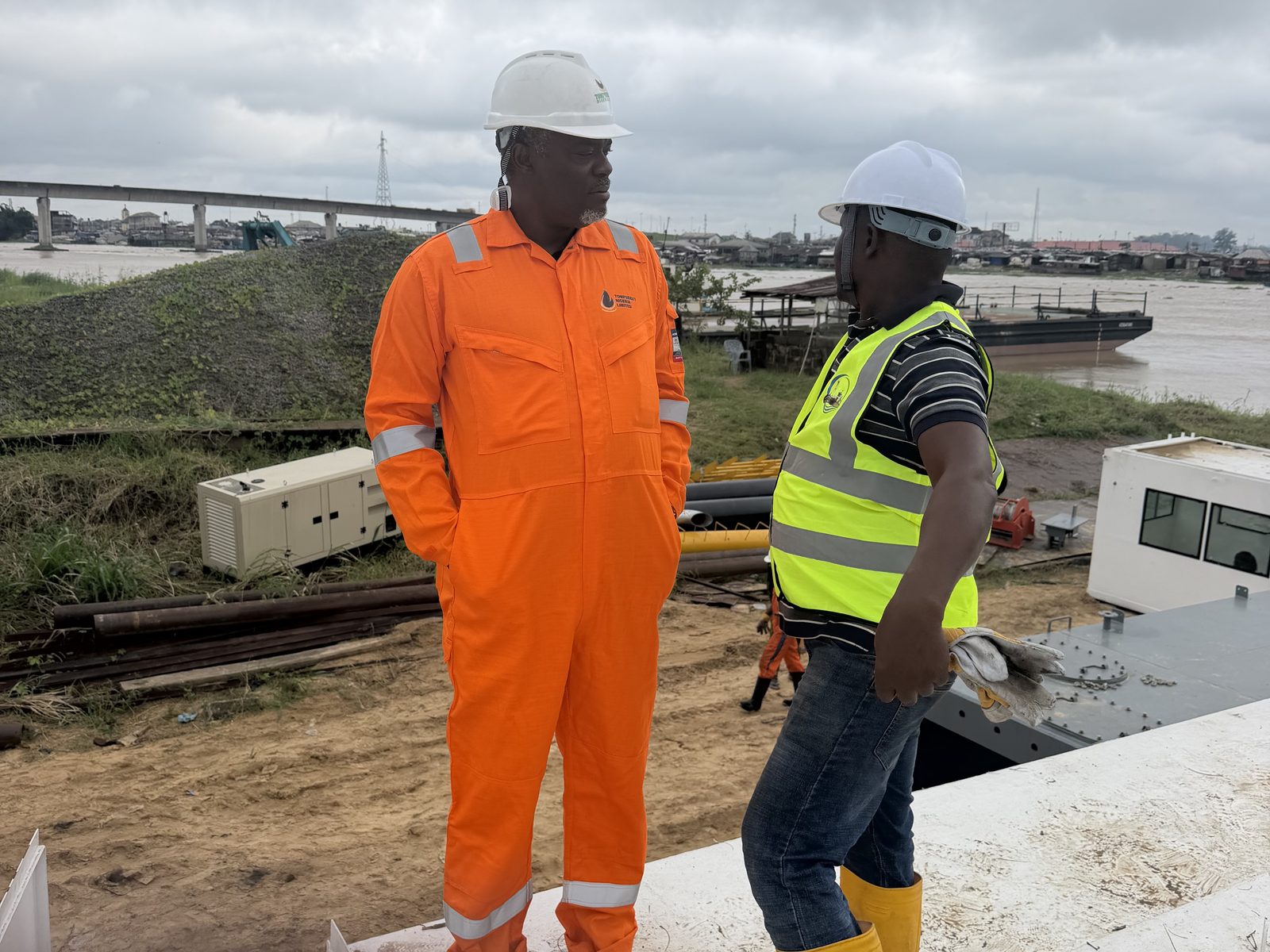 Supervisors on the dredger deck with the river behind