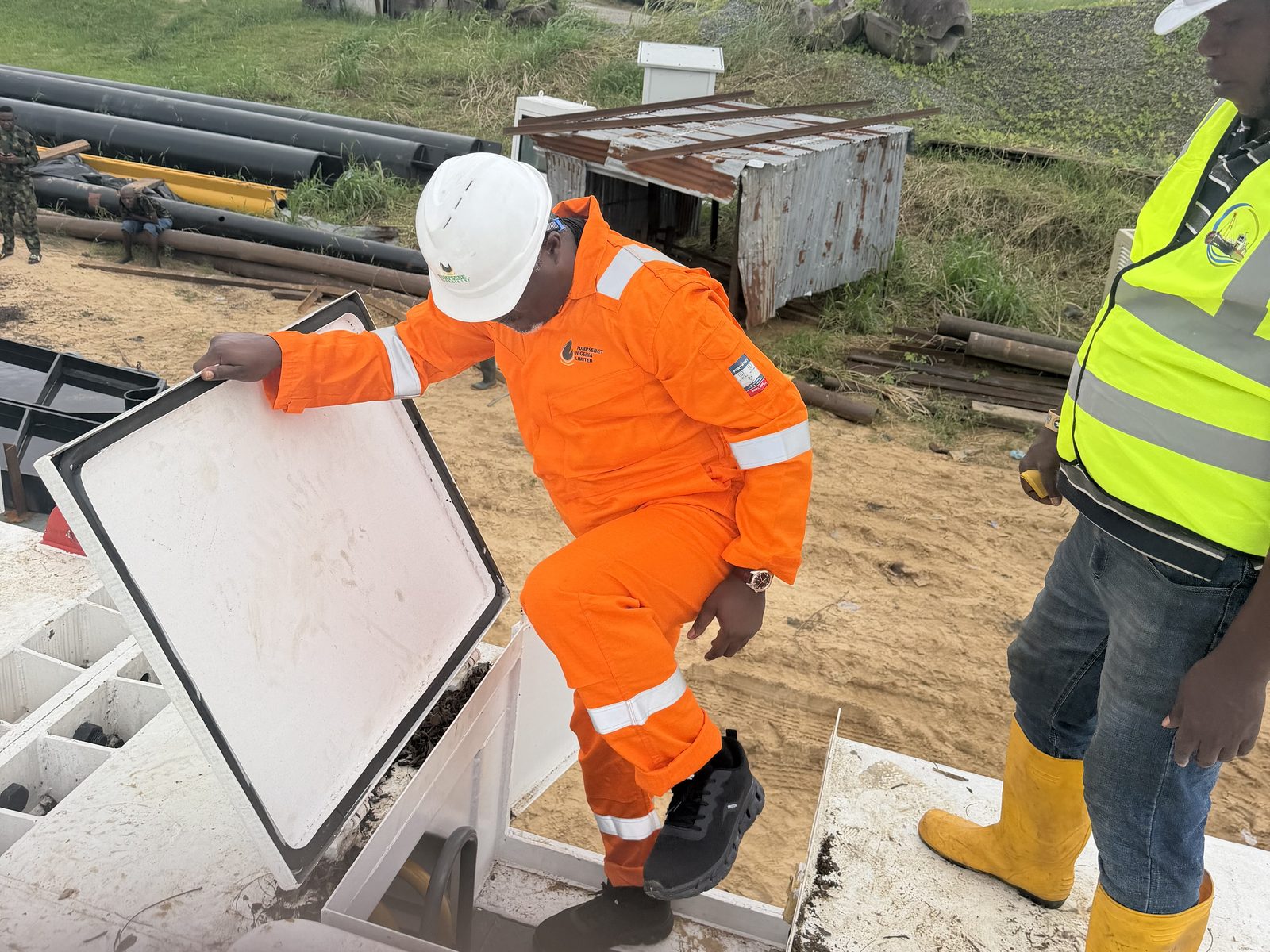 Engineer opening a deck hatch during dredger commissioning checks