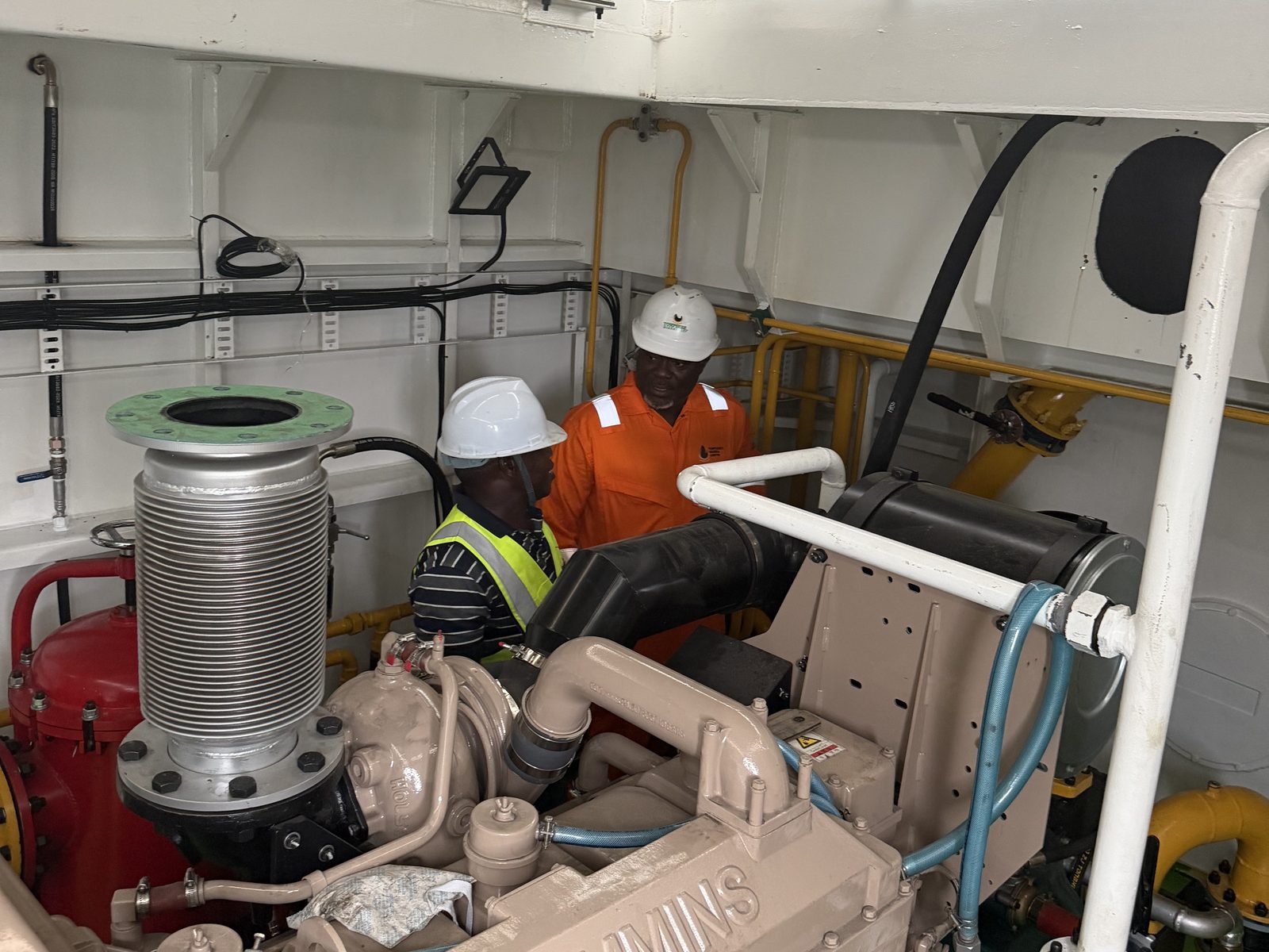 Engineers checking engine room pipework and exhaust bellows