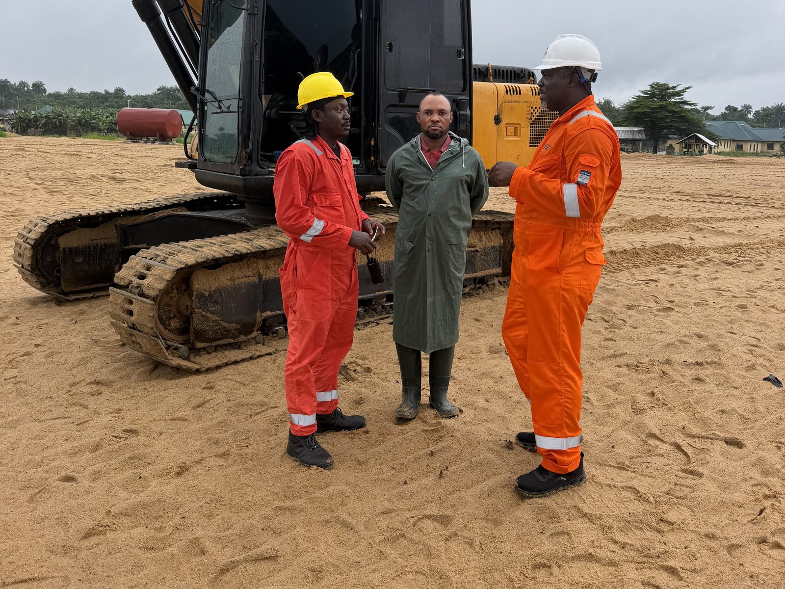Excavator and crew on a sand reclamation site